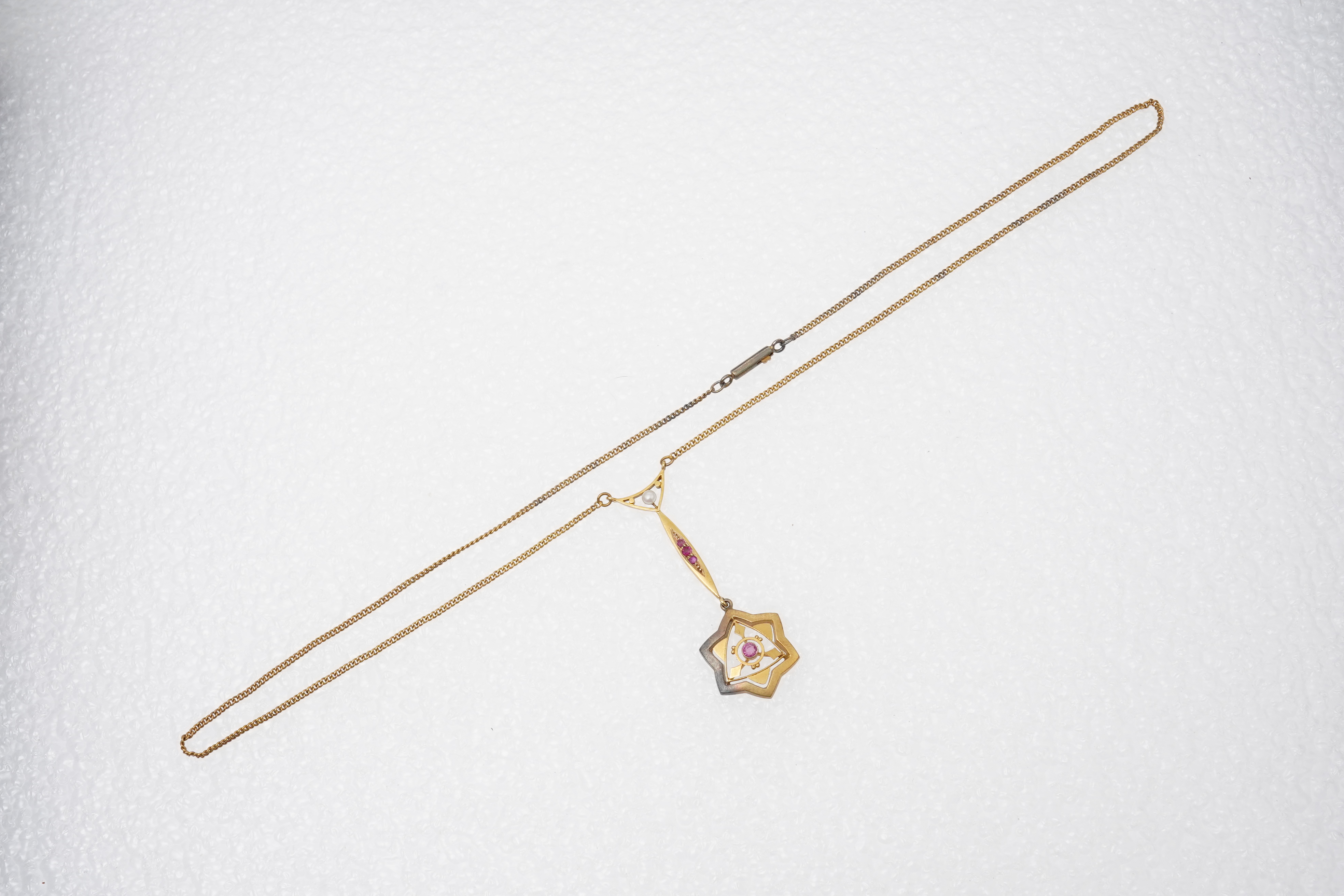 A gold, ruby and seed pearl pendant necklace, early 20th century